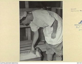 TOROKINA, BOUGAINVILLE. 1945-04-19. TFX14897 A.E. STREETS, MIXING THE INGREDIENTS FOR ICE CREAM WHICH IS SERVED BY THE RED CROSS SOCIETY TO 2/1 GENERAL HOSPITAL PATIENTS