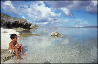 Young boy looking out to sea