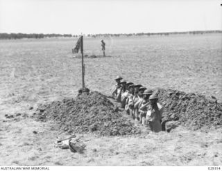 FORBES, NSW. 1943-02. "GUINEA PIGS" TAKING PART IN AN EXPERIMENTAL GAS SHELL SHOOT BY 2/2 FIELD REGIMENT, ROYAL AUSTRALIAN ARTILLERY, IN A TRENCH IN THE CENTRE OF THE TARGET