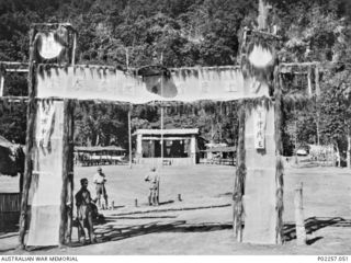 Rabaul, New Britain, 1945-10. The entrance to a Japanese prisoner-of-war (POW) camp for captured soldiers of the Nationalist Chinese Army. The gateway is a bamboo structure which the former POWs ..