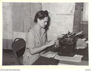 LAE, NEW GUINEA, 1945-05-16. LIEUTENANT J. LOVE, ADMINISTRATIVE OFFICER, AUSTRALIAN WOMEN'S ARMY SERVICE, AT HER DESK IN THE OFFICE OF THE CHIEF SIGNAL OFFICER, HEADQUARTERS FIRST ARMY. AUSTRALIAN ..