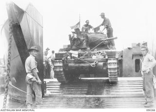TOROKINA BEACHHEAD, BOUGAINVILLE, 1945-03-30. A MATILDA TANK OF B SQUADRON, 2/4TH ARMOURED REGIMENT, MOVING ONTO AN AMERICAN LANDING CRAFT TRANSPORT FOR TRANSPORTATION TO TOKO. IDENTIFIED PERSONNEL ..