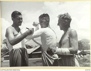 NEW GUINEA. 1943-11-19. AT AN AUSTRALIAN FIELD HOSPITAL PRIVATE (PTE) E. HARGRAVES OF TWEED HEADS N.S.W. AUTOGRAPHS THE PLASTER OF PTE J. WILMOT OF BERRY N.S.W. WHILE CORPORAL W.H. LE FEVRE OF ..