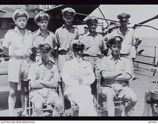 OCEAN ISLAND. 1945-10-01. LIEUTENANT COMMANDER M. G. ROSE, COMMANDER HMAS DIAMANTINA, WITH A GROUP OF HIS OFFICERS, AFTER THE SURRENDER CEREMONY HELD ABOARD HMAS DIAMANTINA WHEN LIEUTENANT ..