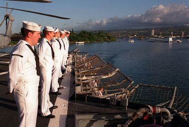 Crew members man the rails aboard the guided missile cruiser USS CHOSIN (CG-65) as the ship passes the USS ARIZONA MEMORIAL during an observance commemorating the 50th anniversary of the Japanese attack on Pearl Harbor