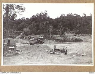 DREGER HARBOUR, NEW GUINEA. 1943-12-06. ENGINEERS OF THE 870TH UNITED STATES AVIATION ENGINEER BATTALION EXTRACTING BALLAST FROM AN ANCIENT CORAL DEPOSIT TO BE USED FOR THE CONSTRUCTION OF THE NEW ..