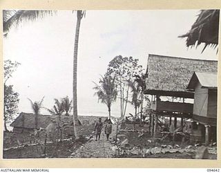 SIPILANGAN, NEW BRITAIN, 1945-08-01. THE AUSTRALIAN NEW GUINEA ADMINISTRATIVE UNIT DISTRICT SERVICES TOL REFUGEE CAMP. A EUROPEAN HOUSE CAN BE SEEN ON THE RIGHT AND NATIVE STORE HOUSES ARE AT LEFT. ..