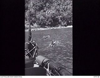 BAM ISLAND, NEW GUINEA. 19 JUNE 1944. ISLAND NATIVES FERRYING MEMBERS OF A PATROL FROM THE 24TH INFANTRY BATTALION ASHORE TO INVESTIGATE RUMOURS OF A JAPANESE RADIO STATION ON THE ISLAND