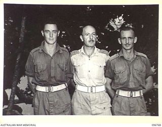 CAPE WOM, NEW GUINEA, 1945-09-17. CAPTAIN E.J. HABERFIELD, OFFICER COMMANDING SKIN WARD, 2/7 FIELD AMBULANCE (2) WITH TWO OF HIS MEDICAL ORDERLIES, CORPORAL K. FERRELLY (1); PRIVATE L.R. DE VRIES ..