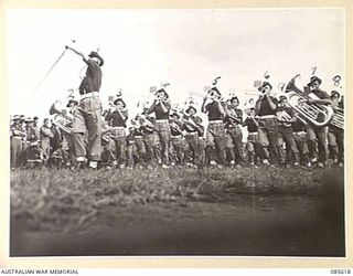 HERBERTON RACECOURSE, WONDECLA, ATHERTON TABLELAND, QLD. 1945-01-19. THE 2/13 INFANTRY BATTALION BAND COMPETING IN THE BAND CONTEST DURING THE 9 DIVISION GYMKHANA. (FOR IDENTIFICATION OF 14 NAMED ..