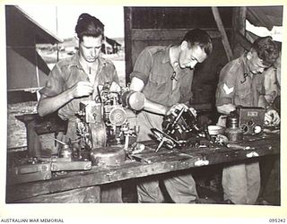 CAPE WOM, WEWAK AREA, NEW GUINEA, 1945-08-14. FITTERS OF THE MAINTENANCE SECTION 6 DIVISION SIGNALS, REPAIRING BATTERY CHARGING EQUIPMENT. THE MEMBERS ARE: SIGNALMAN R.J. MCCULLOCH (1); SIGNALMAN ..