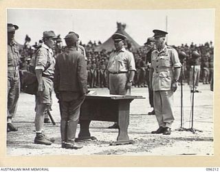 CAPE WOM, NEW GUINEA, 1945-09-13. LIEUTENANT-GENERAL ADACHI, COMMANDER 18 JAPANESE ARMY IN NEW GUINEA, DISCUSSING THE TERMS OF SURRENDER WITH MAJOR-GENERAL H.C.H. ROBERTSON, GENERAL OFFICER ..