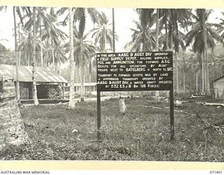FINSCHHAFEN AREA, NEW GUINEA. 1944-03-21. THIS SIGN MARKS THE POSITION OF THE FIELD SUPPLY DEPOT OPERATED BY THE AUSTRALIAN ARMY SERVICE CORPS, 9TH DIVISION SUPPLYING AUSTRALIAN TROOPS WEST TO ..