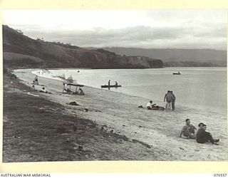 PORT MORESBY, PAPUA, 1944-02-20. MEMBERS OF THE AUSTRALIAN ARMY MEDICAL WOMEN'S SERVICE RELAXING WITH FRIENDS AT THE BEACH IN FRONT OF THE AUSTRALIAN WOMEN'S SERVICES CLUB, CONDUCTED BY THE ..