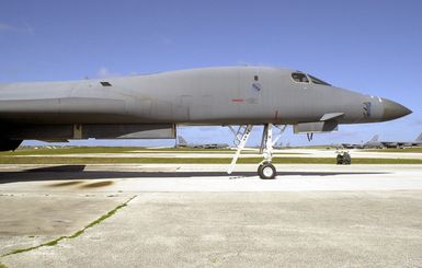 A US Air Force (USAF) B-1B Lancer, 7th Bomb Wing (BW), Dyess Air Force Base (AFB), Texas (TX), parked on the ramp with B-52H Stratofortress, 2nd BW, Barksdale AFB, Louisiana (LA), in the background on the ramp at Andersen AFB, Guam. The bombers are here supporting the 7th Air Expeditionary Wing's (AEW) mission