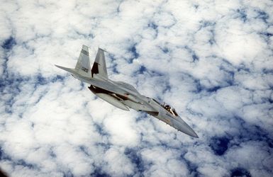 An F-15A from the 199th Fighter Squadron, Hawaii Air National Guard, slides away after receiving fuel from a KC-135 from the 203rd Air Refueling Squadron, Hawaii Air National Guard, over the Pacific Ocean