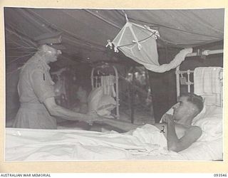 TOROKINA, BOUGAINVILLE. 1945-07-03. HIS ROYAL HIGHNESS, THE DUKE OF GLOUCESTER, GOVERNOR-GENERAL OF AUSTRALIA (1), SHAKING HANDS WITH CAPTAIN MATTHEWS (2), DURING HIS VISIT TO 2/1 GENERAL HOSPITAL