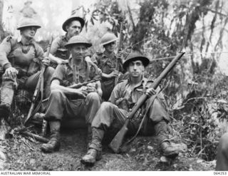 FINISTERRE RANGES, NEW GUINEA. 1944-01-23. PERSONNEL OF "D" COMPANY, 2/9TH INFANTRY BATTALION, AWAITING TO MOVE INTO ACTION DURING THE BATTLE FOR SHAGGY RIDGE. THEY ARE, LEFT TO RIGHT, BACK ROW:- ..