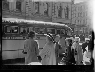 Unidentified group waiting at a Johnston's Airways Transport bus in Auckland at the beginning of White's Fiji tour
