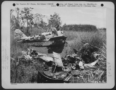 Members of the 41st Division looking over Japanese Zero which was wrecked on the Old Jap Air Strip, Buna, Papua, New Guinea by bombing. 11 March 1943. (U.S. Air Force Number 77911AC)