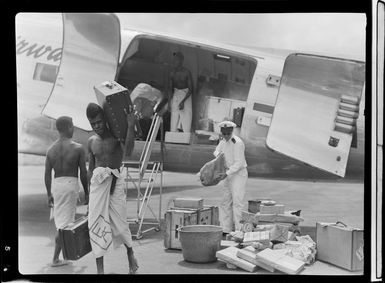 Locals unloading Qantas aircraft, Rabaul airfield, Papua New Guinea
