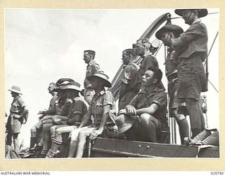 PORT TEWFIK, EGYPT. 1942-02. THESE MEN OF THE A.I.F. ON THEIR WAY HOME FROM THE MIDDLE EAST GET A GOOD VIEW OF WHATS HAPPENING AHEAD FROM THE LIFEBOAT OF THEIR TROOPSHIP