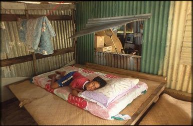 Child lying on mattress