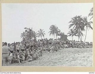 TOROKINA, BOUGAINVILLE, 1945-07-08. A SECTION OF THE LARGE CROWD WHICH TURNED OUT TO WATCH THE CHAMPIONSHIP SURF CARNIVAL HELD BY SOLOMON ISLAND SURF LIFE SAVING CLUB CONDUCTED BY ARMY AMENITIES ..