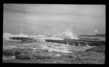 [Waves breaking on rocky beach in Guam]