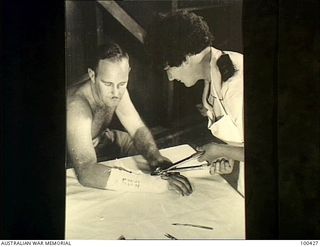 Port Moresby, New Guinea. 1944-05-09. VFX92823 Lieutenant J. Dickson, of the Physiotherapy Department at the 128th Australian General Hospital, removing a plaster cast from the wrist of NX13391 ..