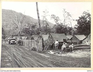 NAMANULA, NEW BRITAIN. 1945-10-10. THE TRIM TENT LINES AT HEADQUARTERS 11 DIVISION. THE JAPANESE ARE BUILDING A SPLIT BAMBOO FENCE AROUND THE AREA