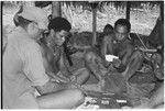 Men playing cards; in middle is Winitaemu