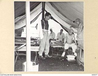 CAPE WOM, WEWAK AREA, NEW GUINEA. 1945-08-28. CORPORAL J.S. CLARKE, 104 CASUALTY CLEARING STATION IN A TENT AT AN AUSTRALIAN HOSPITAL COMPOUND FOR JAPANESE PRISONERS OF WAR. THE JAPANESE SHAVING ..