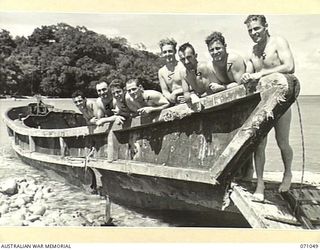 SCARLET BEACH, FINSCHHAFEN AREA, NEW GUINEA. 1944-03-13. AUSTRALIAN TROOPS ON ONE OF THE SMASHED JAPANESE BARGES THAT LITTERS THE SHORE. THE BARGES WERE DESTROYED BY THE 24TH INFANTRY BRIGADE GROUP ..