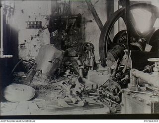 Fanning Island. September 1914. The interior of the destroyed Engine Room on Fanning Island. In the background is the destroyed switch board, and in the foreground the destroyed dynamo (a type of ..