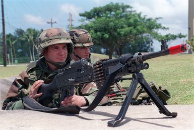 Specialists (SPC) Jeff Miller and SPC Micheal Swanson both US Army (USA) assigned to A/Company, 1ST Battalion, 17th Infantry Division guard their defensive position at Orote Point, Guam while manning a 7.62mm M240G Machine Gun, during Exercise TANDEM THRUST '99