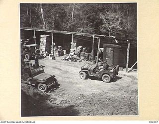 MAKOW, NEW GUINEA. 1945-08-06. THE FORWARD DETAIL ISSUE DEPOT, HEADQUARTERS COMMAND AUSTRALIAN ARMY SERVICE CORPS 6 DIVISION, NEAR THE SUMMIT OF THE BIG ROAD. THIS MOUNTAIN DETAIL ISSUE DEPOT WAS ..