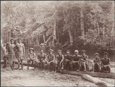 Men of Bulalaha sitting beside river, Malaita, Solomon Islands, 1906 / J.W. Beattie