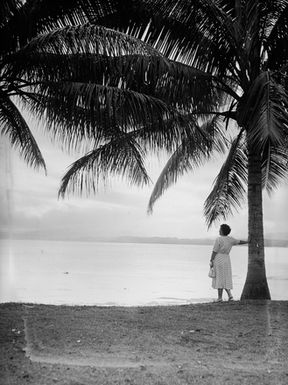 [Woman looking out to sea from Pacific Island waterfront]