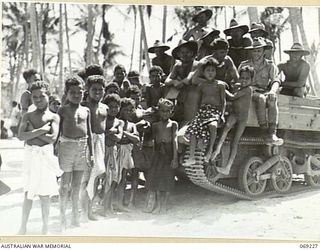 NEW GUINEA. 1942. NATIVE CHILDREN TAKING A KEEN INTEREST IN A BREN GUN CARRIER, MANNED BY AUSTRALIAN TROOPS, WHO WERE PRESENT AS A COVER PATROL DURING THE VISIT OF PPI. MAJOR GENERAL B.M. MORRIS, ..
