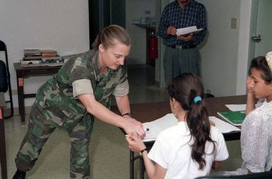 US Marine Captain K. E. Phelps volunteers her time to teach evacuee children english and math in support of Operation PACIFIC HAVEN. PACIFIC HAVEN provided over 6,000 pro-US Kurds from Northern Iraq humanitarian assistance and political asylum