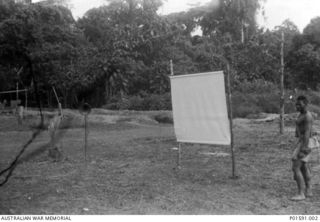 MARKHAM VALLEY, NEW GUINEA. C.1945. SCREEN USED FOR SLIDE PROJECTION AT SHOWS FOR THE NATIVES BY THE MOBILE PROPAGANDA UNIT, FAR EASTERN LIAISON OFFICE