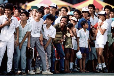 Enthusiastic Indonesian spectators watch a performance by the US Air Force Thunderbirds flight demonstration team. The Thunderbirds are performing in Indonesia as part of their 1987 Pacific tour which encompasses nine countries and Guam