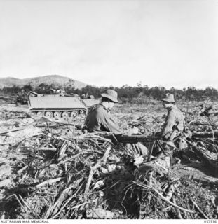 KAIAPIT, NEW GUINEA. 1943-09-23. SX13290 PRIVATE (PTE) M. D. AUSTIN (LEFT) AND SX13334 PTE W. G. SHATTOCK, BOTH OF THE 2/27TH AUSTRALIAN INFANTRY BATTALION, CLEANING A VICKERS GUN PRIOR TO SETTING ..