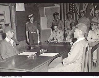 TOROKINA, BOUGAINVILLE. 1945-09-08. LIEUTENANT-GENERAL (LT-GEN) M. KANDA, COMMANDER, 17TH JAPANESE ARMY AND VICE ADMIRAL BARON SAMEJIMA SEATED AT THE SURRENDER TABLE AT HQ 2 CORPS IN READINESS FOR ..