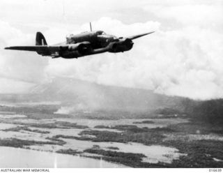 New Britain. 6 March 1944. A Beaufort bomber aircraft of No. 100 Squadron RAAF over the coast of New Britain after a bombing raid on the Japanese. Note the bomb burst in the low-lying coastal area. ..