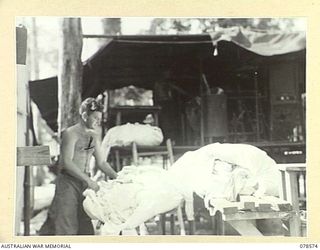BOUGAINVILLE ISLAND. 1945-01-23. QX57851 LANCE CORPORAL R.V. PRICE (1) OPERATING THE MOBILE LAUNDRY AT THE 109TH CASUALTY CLEARING STATION