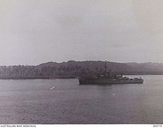 MADANG HARBOUR, PNG. 1944-05. PORT SIDE VIEW OF THE CORVETTE HMAS GOULBURN (J167). SHE HAS BEEN CAMOUFLAGED IN A DARK GREY COLOUR, POSSIBLY G10. HER ORIGINAL 4 INCH GUN FORWARD APPEARS TO HAVE BEEN ..