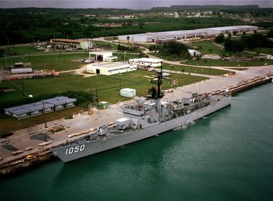 A port view of the frigate USS ALBERT DAVID (FF 1050) moored in the harbor