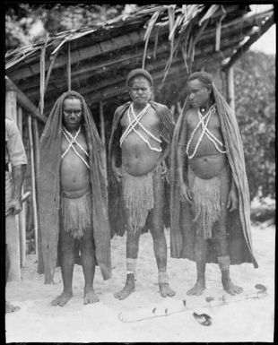 Three Kukukuku men wearing bark rain hoods, Salamaua, New Guinea, 1933 / Sarah Chinnery